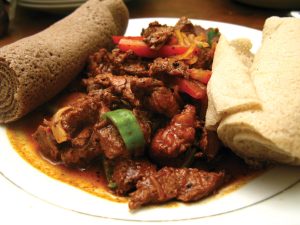 Traditional Eritrean Tsebhi Siga stew served on injera bread with berbere spice blend